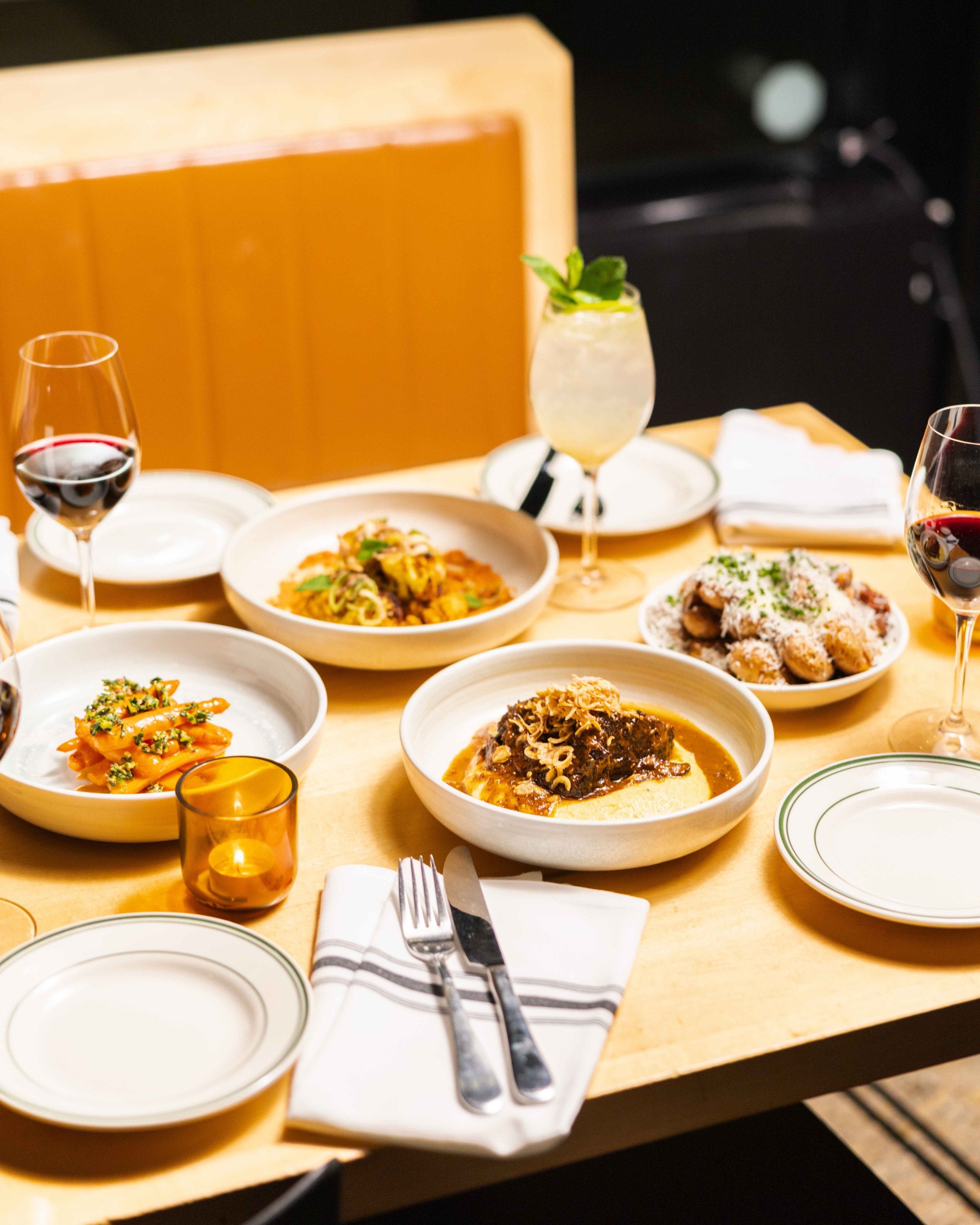 Shared plates from the Market Dinner menu with wine on the table